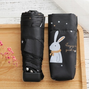 Mini pocketparaply för barn med vit kanin på ett svart paraply på ett träbord