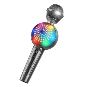 En grå trådlös karaokemikrofon för barn med en centerhögtalare i flera färger